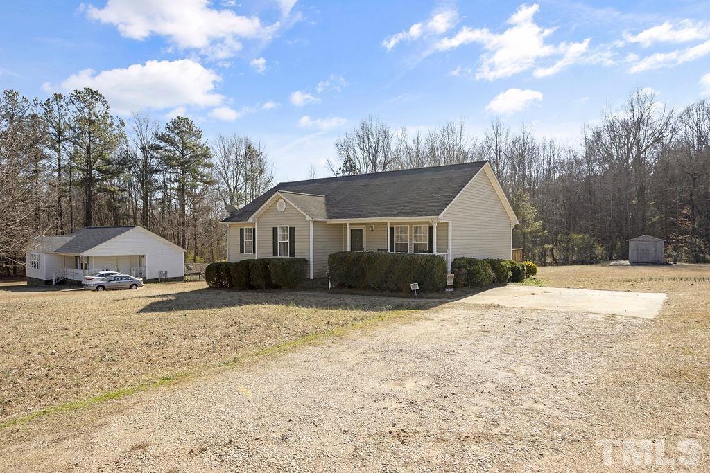 7929 Flower Hill Road Middlesex, NC 27557 - Photo 3 of 28 a front view of a house with a yard covered in snow