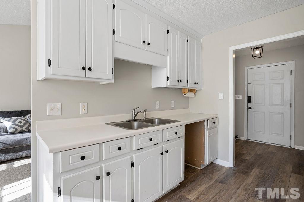 7929 Flower Hill Road Middlesex, NC 27557 - Photo 6 of 28 a kitchen with white cabinets and sink