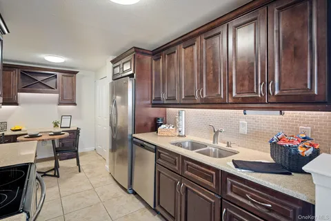a kitchen with stainless steel appliances a sink stove and cabinets
