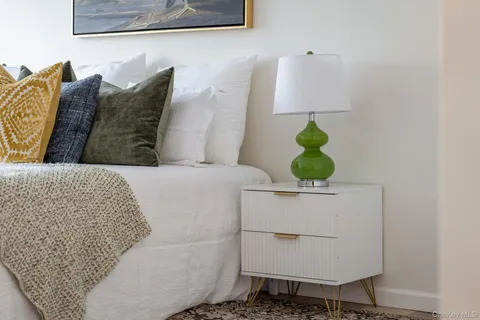 a bathroom with a granite countertop sink toilet and a mirror