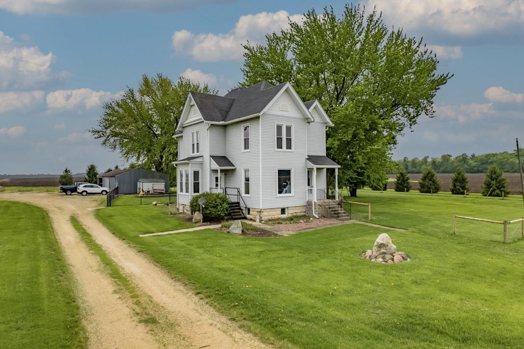 13269 East Holcomb Road Davis Junction, IL 61020 - Photo 24 of 34 a front view of a house with garden and trees