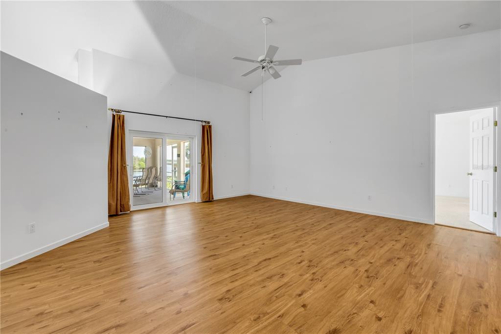 192 Azalea Road Edgewater, FL 32141 - Photo 49 of 94 a view of an empty room with wooden floor and a window