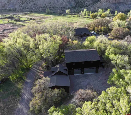 a view of a house with a yard and sitting area