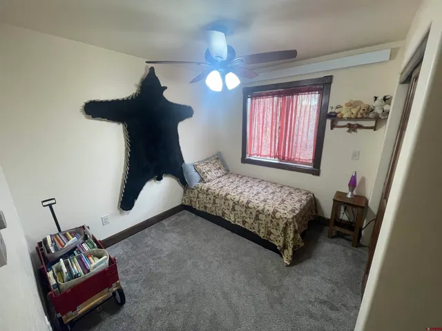 a bedroom with bed and window