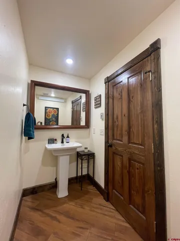 a view of a room that has a couch and a refrigerator in it