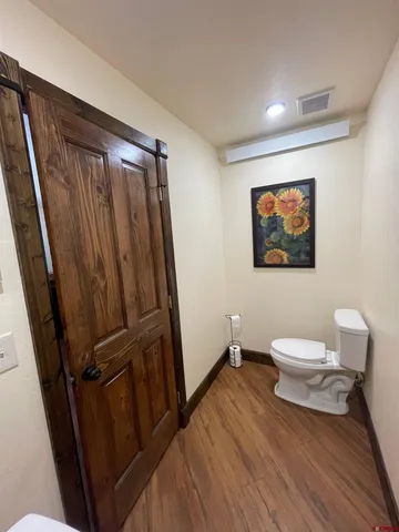 a bathroom with a toilet a sink and a mirror
