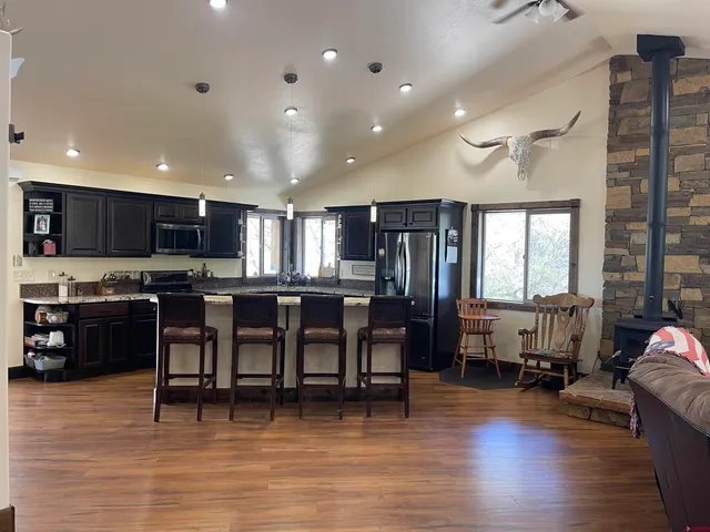 a open kitchen with lots of counter space dining table and chairs