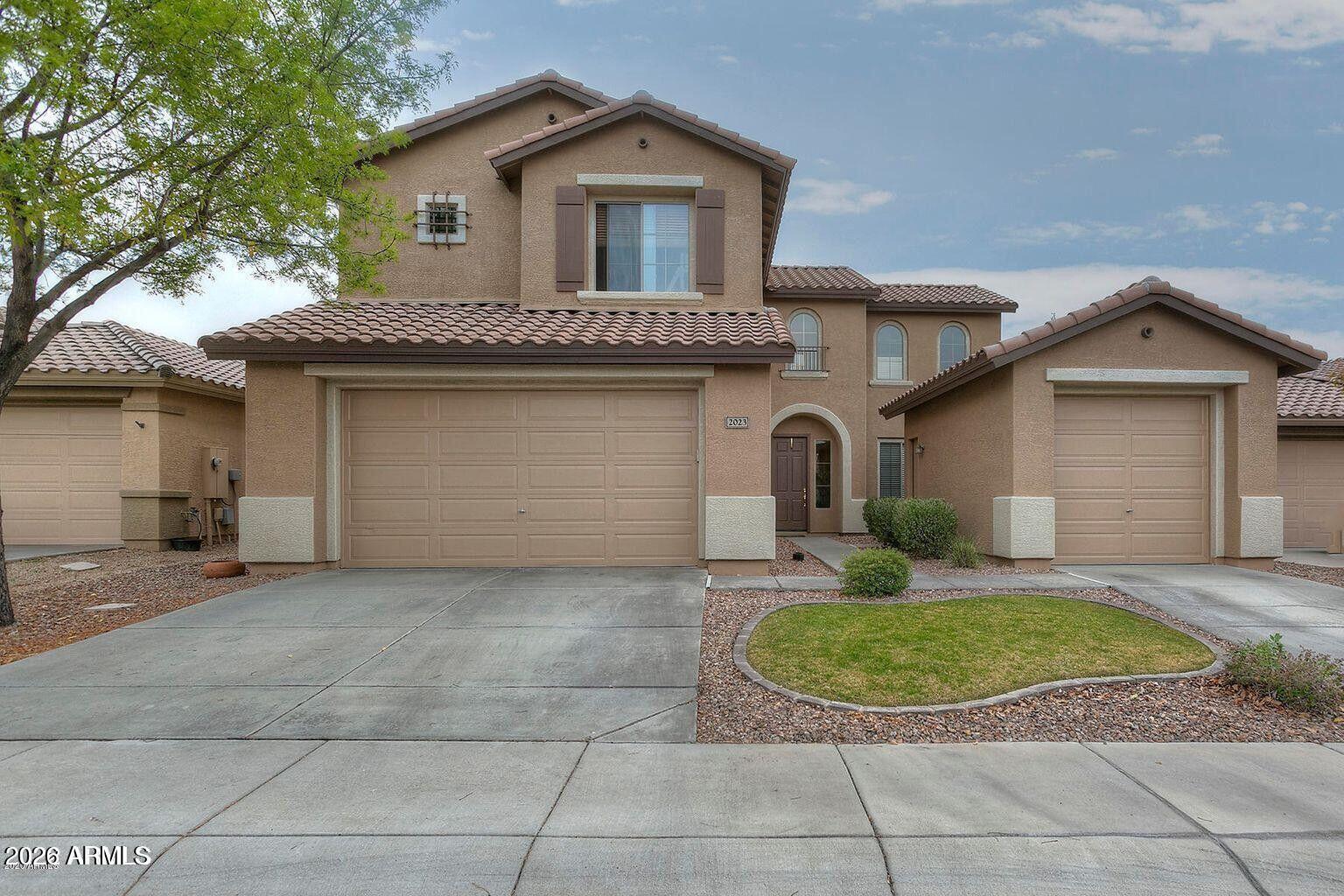 2023 West Shackleton Drive Phoenix, AZ 85086 - Photo 1 of 11 a view of a house with a yard plants and a large tree