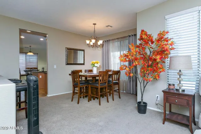 a dining room filled with furniture and a chandelier