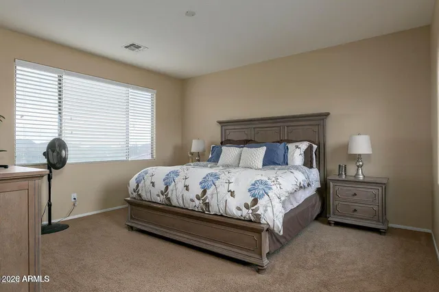 a bedroom with a bed and a window