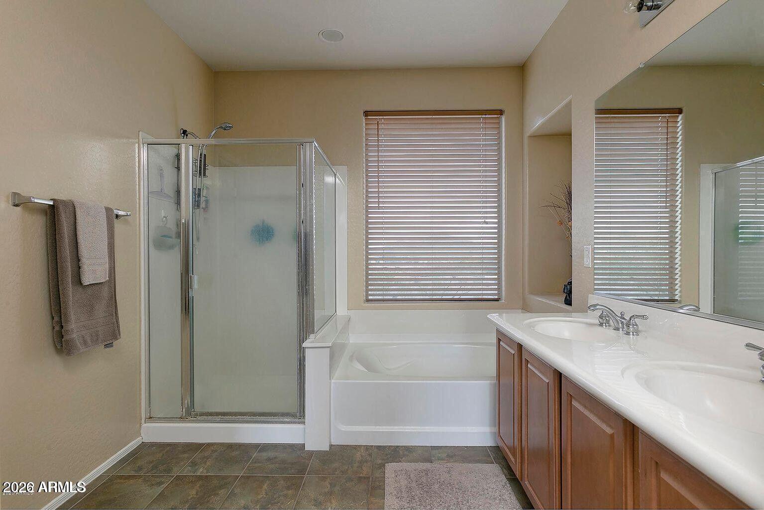 2023 West Shackleton Drive Phoenix, AZ 85086 - Photo 8 of 11 a bathroom with a double vanity sink a large mirror and shower