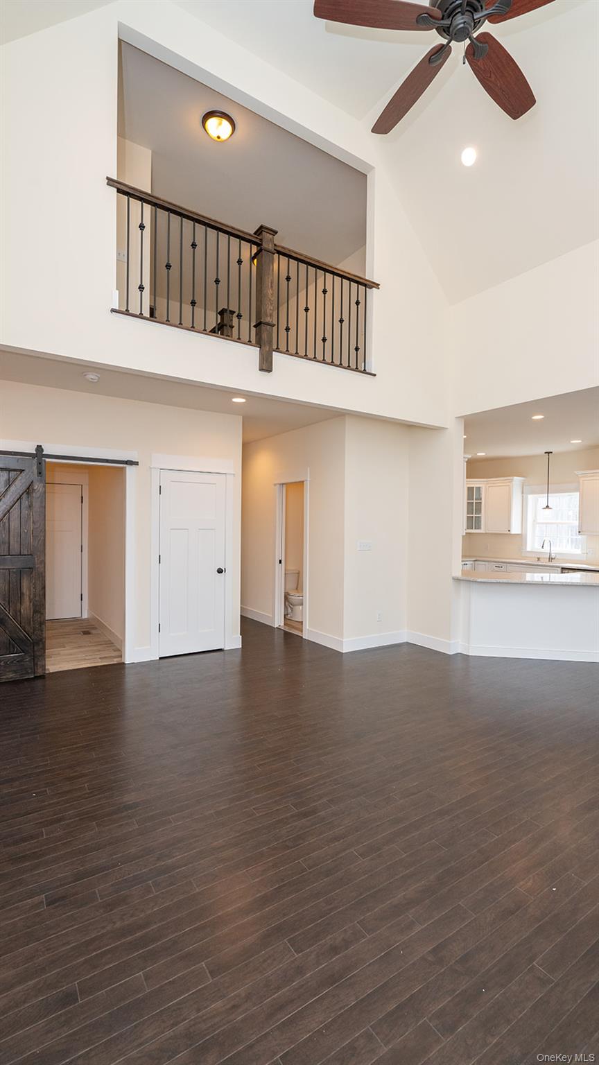 43 Malloy Road Wallkill, NY 12589 - Photo 15 of 50 Unfurnished living room with a barn door, high vaulted ceiling, dark wood finished floors, recessed lighting, and a ceiling fan