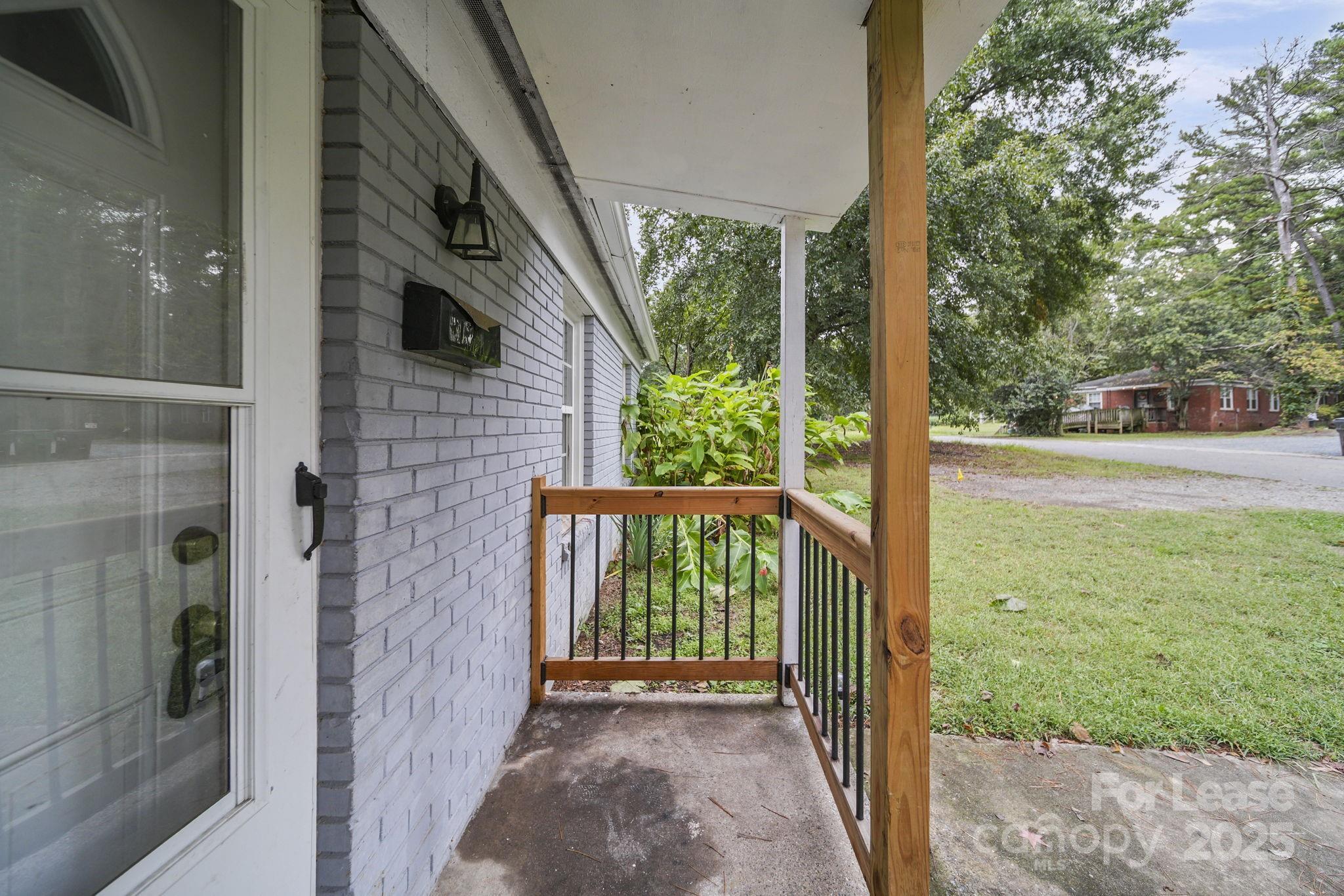 2621 Druid Hls Way, Unit 4 Charlotte, NC 28206 - Photo 11 of 35 a view of porch with a yard
