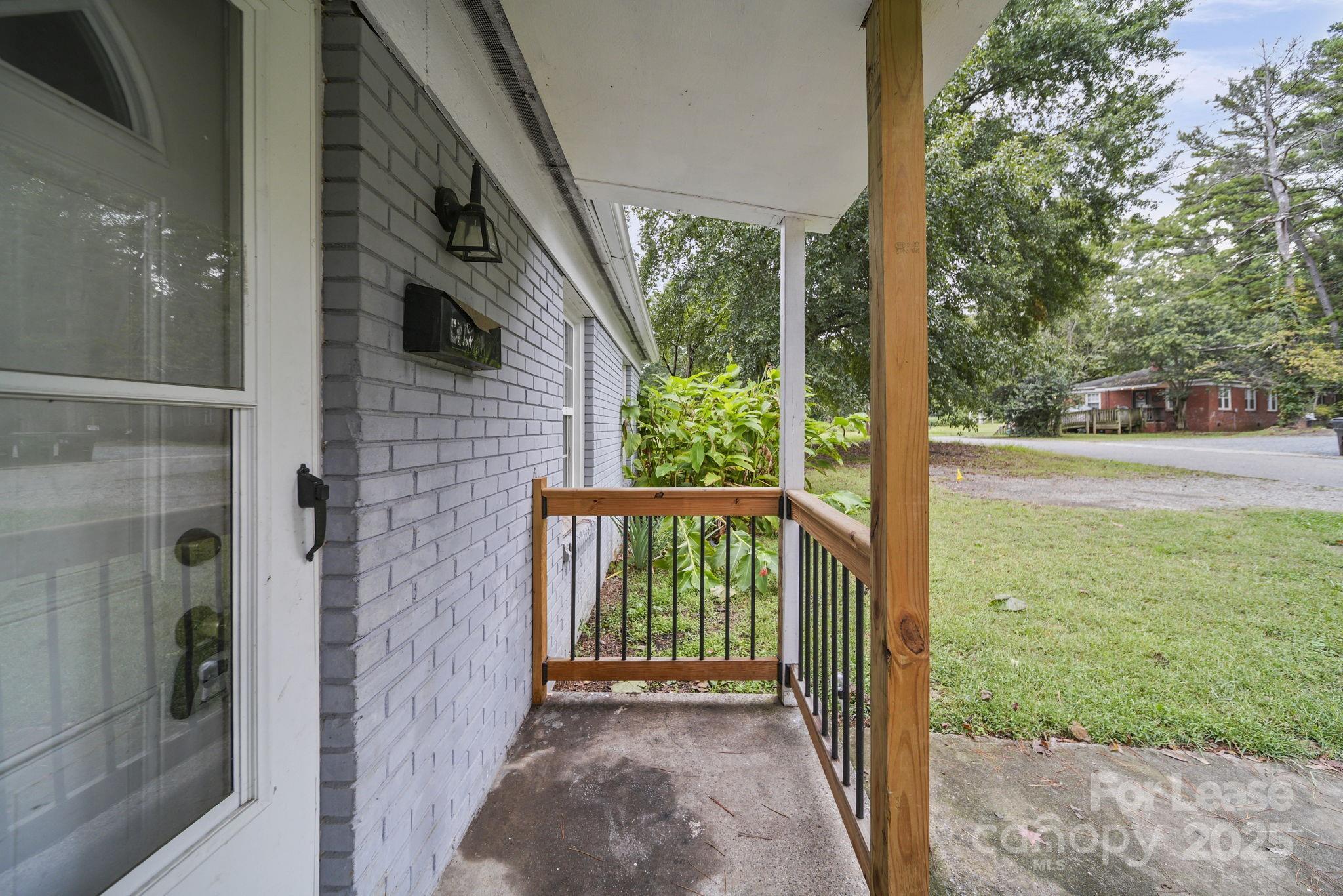 2621 Druid Hls Way, Unit 4 Charlotte, NC 28206 - Photo 12 of 35 a view of a porch with wooden floor and garden
