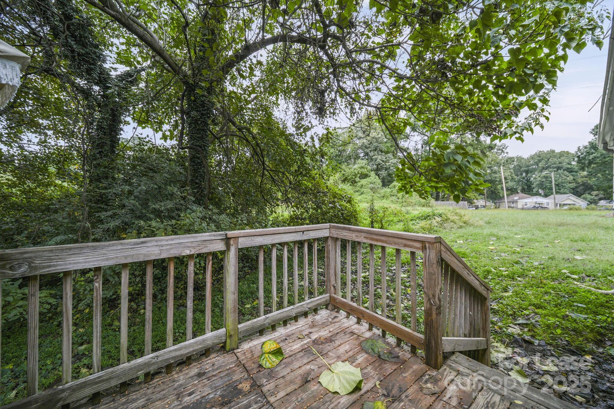 2621 Druid Hls Way, Unit 4 Charlotte, NC 28206 - Photo 13 of 35 a balcony with wooden floor and outdoor space