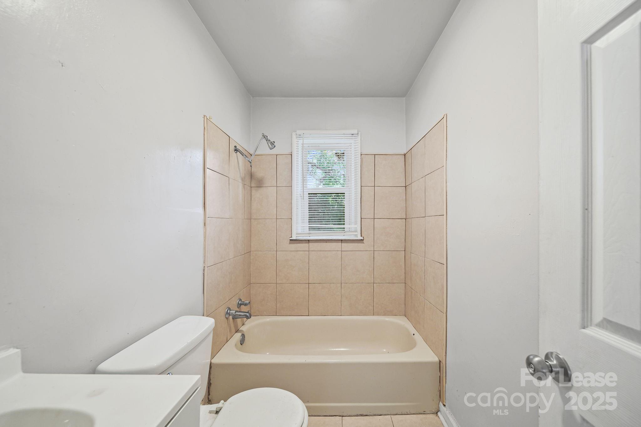 2621 Druid Hls Way, Unit 4 Charlotte, NC 28206 - Photo 19 of 35 a bathroom with a bathtub and shower