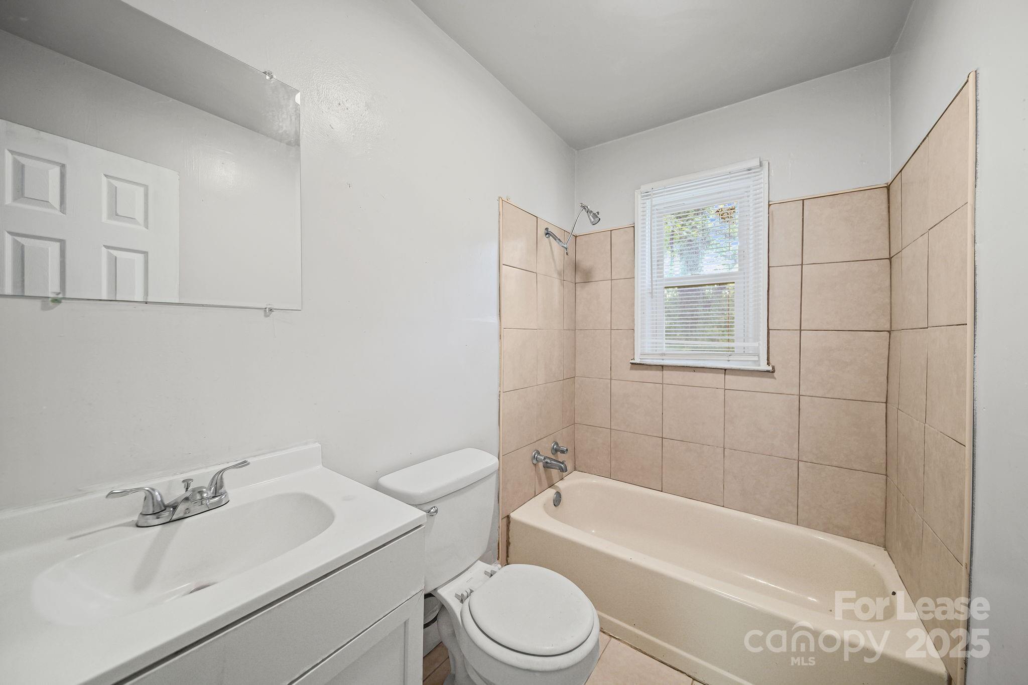 2621 Druid Hls Way, Unit 4 Charlotte, NC 28206 - Photo 20 of 35 a bathroom with a sink toilet and shower