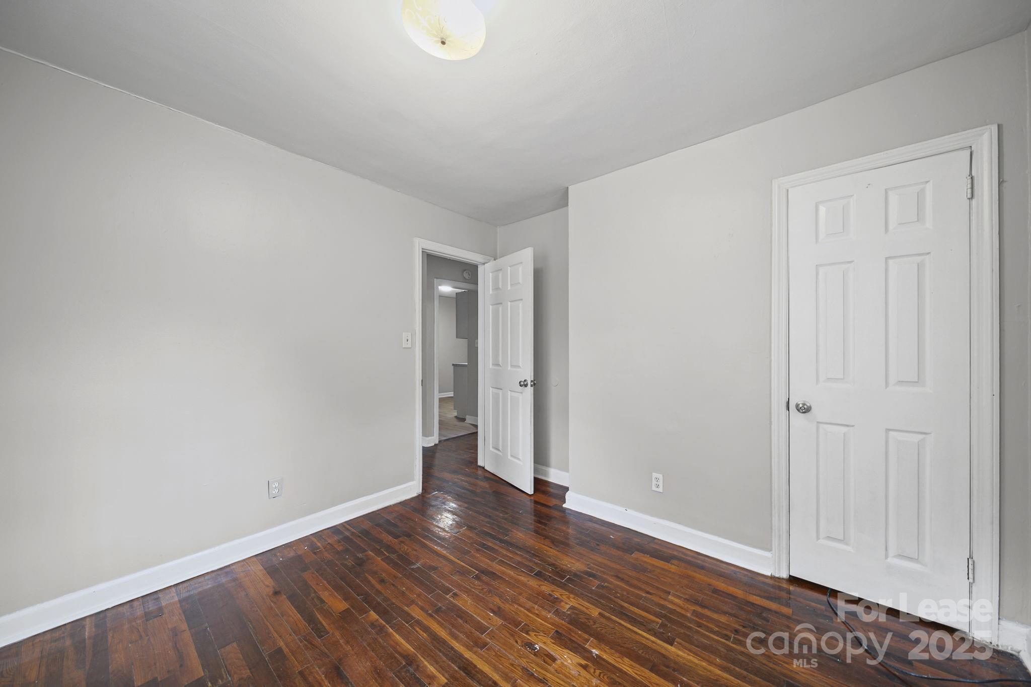 2621 Druid Hls Way, Unit 4 Charlotte, NC 28206 - Photo 26 of 35 a view of an empty room with wooden floor