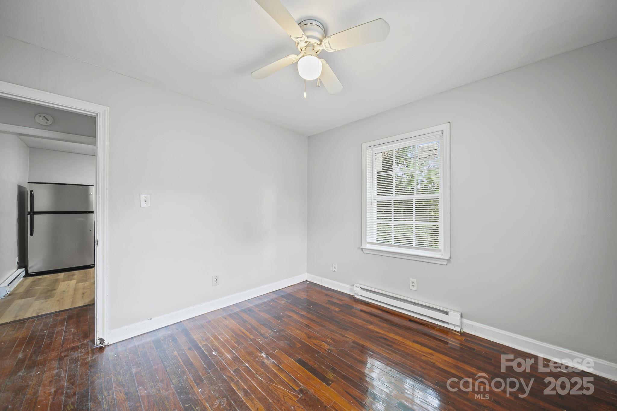 2621 Druid Hls Way, Unit 4 Charlotte, NC 28206 - Photo 27 of 35 wooden floor in an empty room with a window