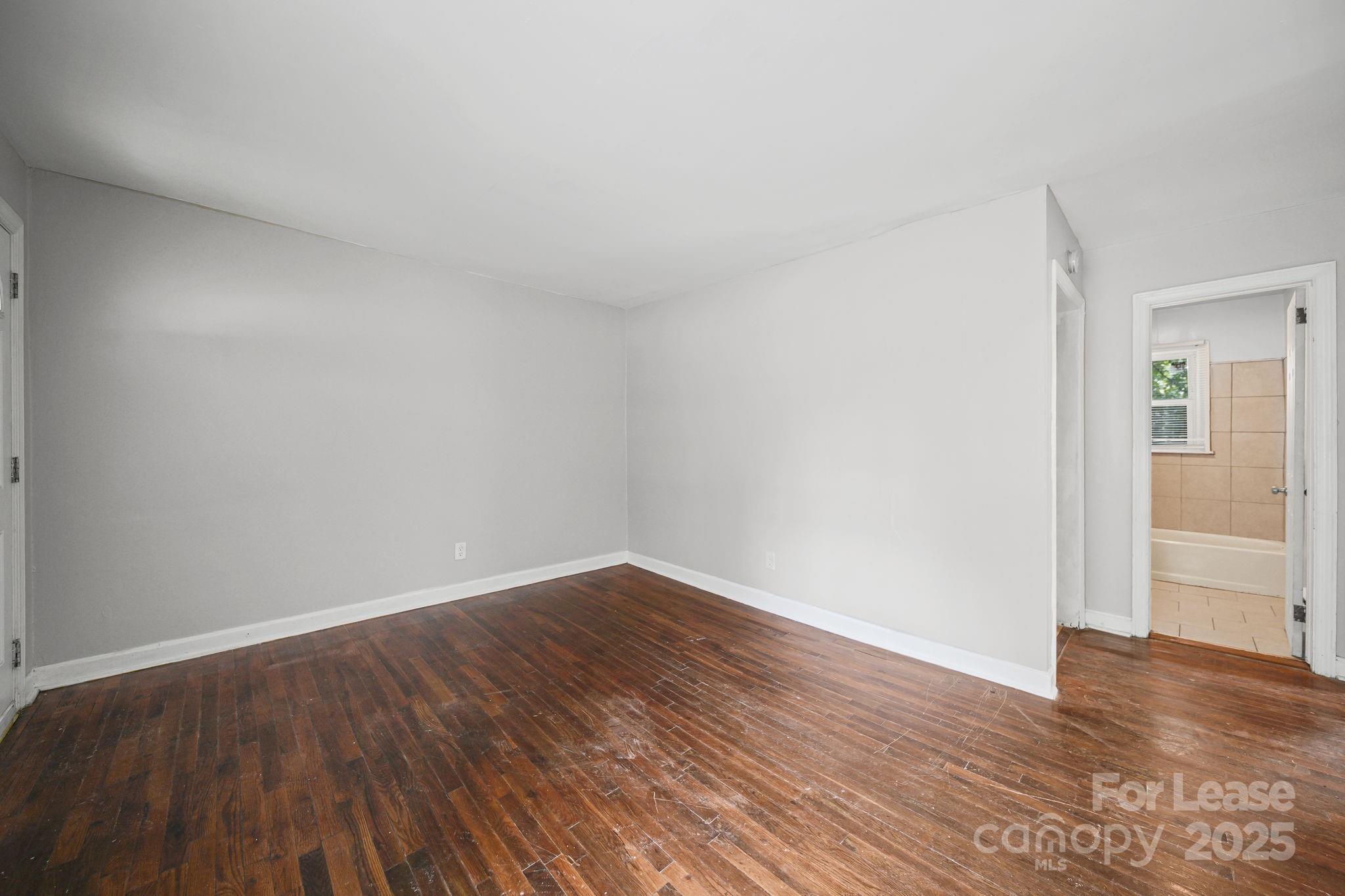 2621 Druid Hls Way, Unit 4 Charlotte, NC 28206 - Photo 28 of 35 a view of an empty room with wooden floor