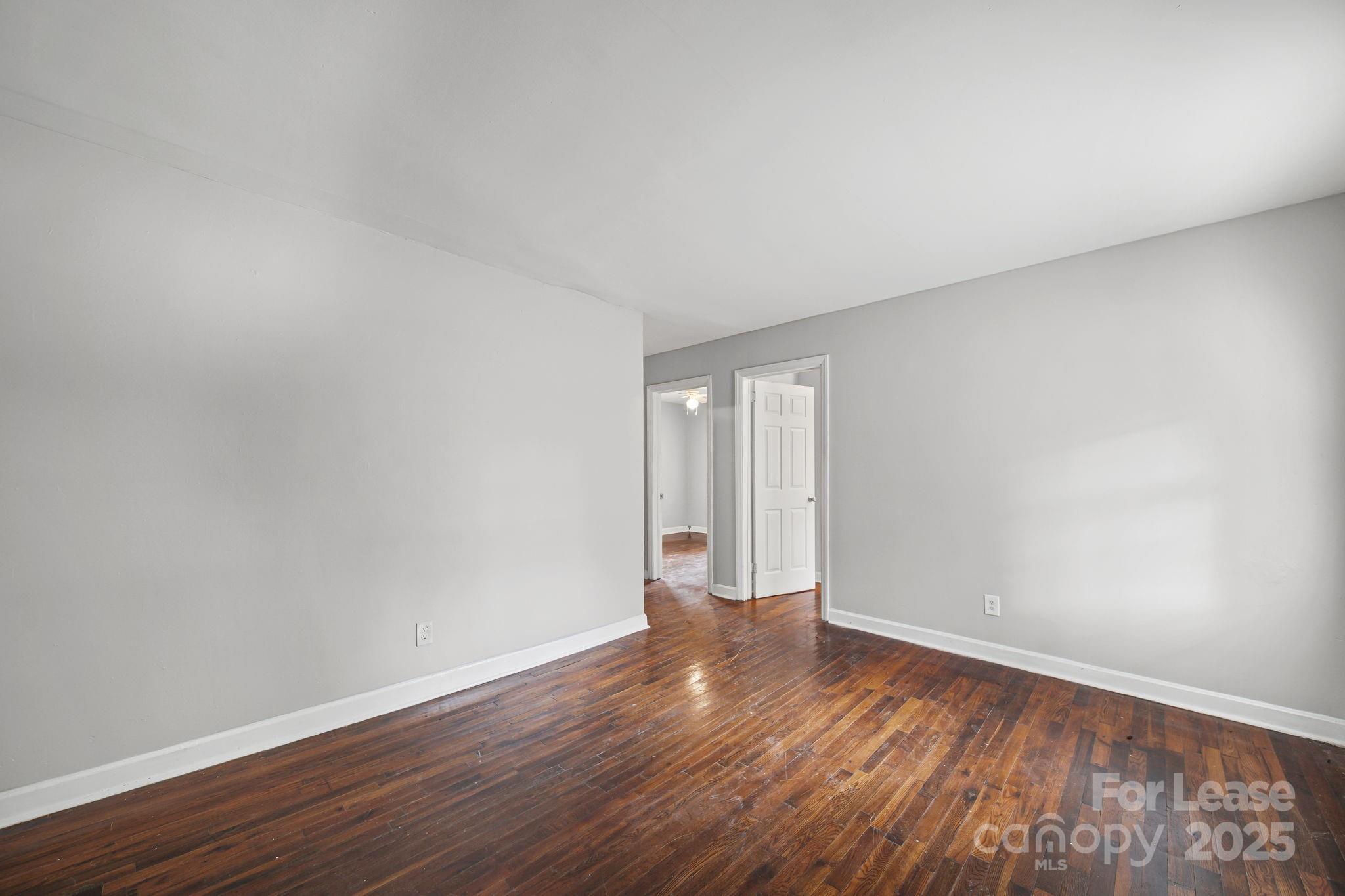 2621 Druid Hls Way, Unit 4 Charlotte, NC 28206 - Photo 33 of 35 a view of an empty room and wooden floor
