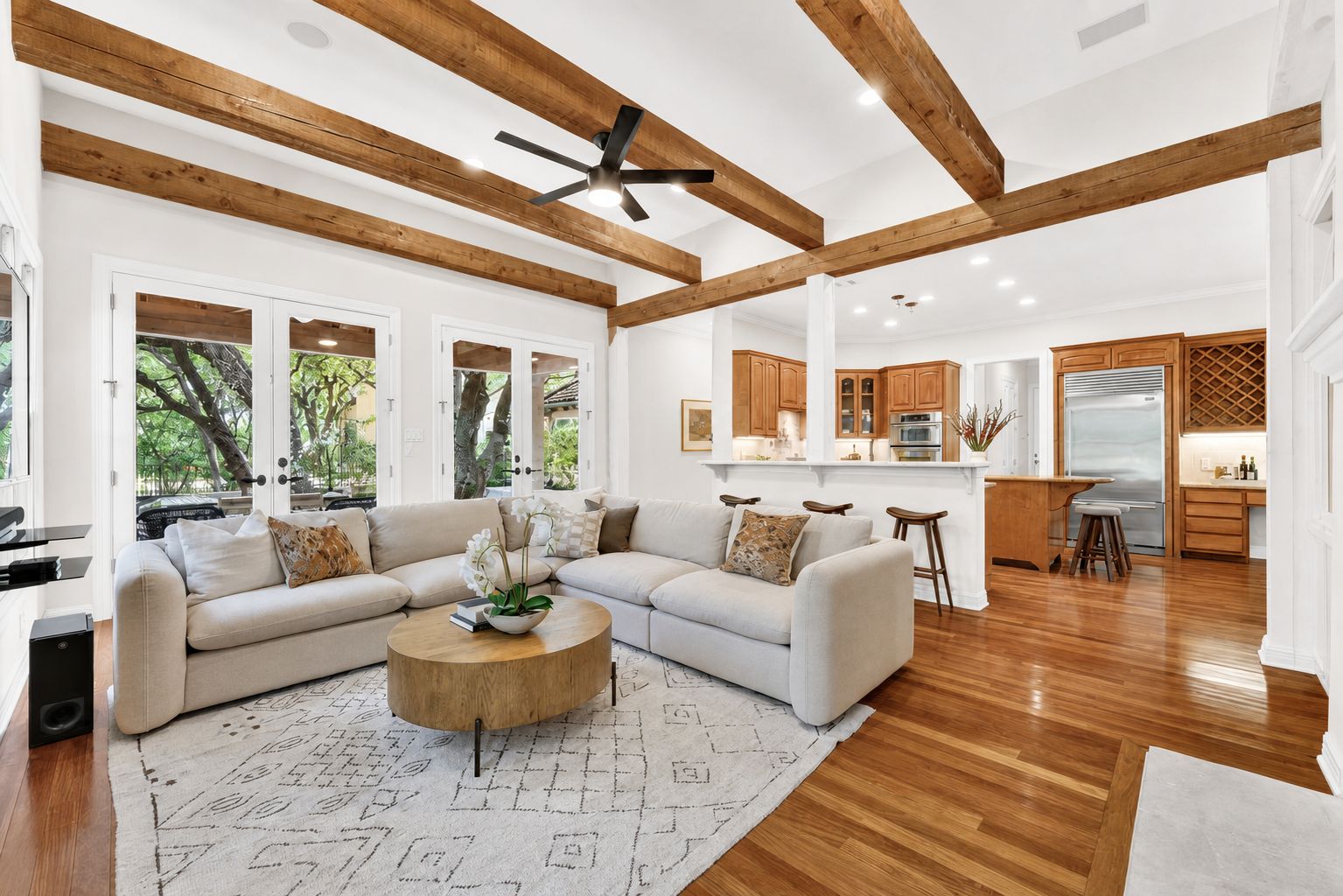 4110 Bunny Run, Unit 3 Austin, TX 78746 - Photo 7 of 35 WHITE PAINT INSPIRATION - Exposed wood beams add architectural interest to this bright, open-concept living area with rich hardwood floors.