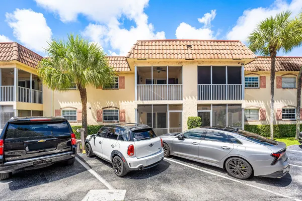 a front view of a house with a parking space