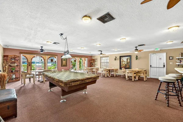 a living room with furniture and pool table