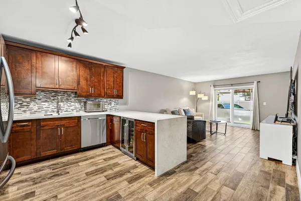 a kitchen with stainless steel appliances granite countertop a stove cabinets and wooden floor