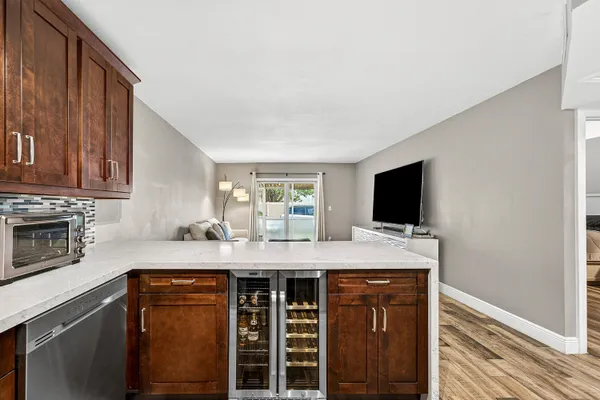 a view of a kitchen counter space and wooden floor