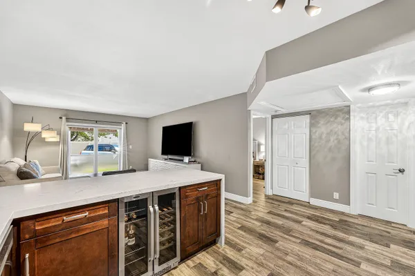 a view of a kitchen with a sink and a refrigerator