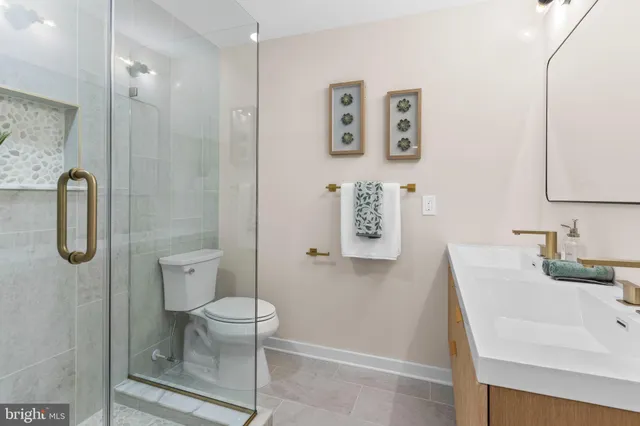 a bathroom with a toilet sink and shower
