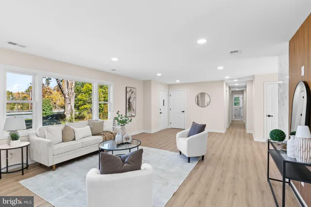 a living room with furniture or wooden floor and a large window