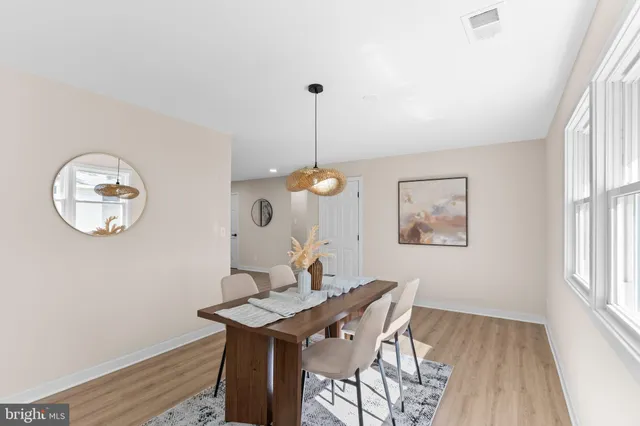 a view of a dining room with a table and chairs