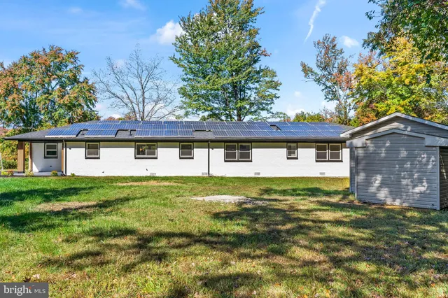 a front view of house with yard and trees