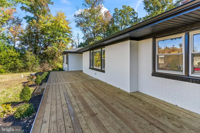 a view of backyard with wooden floor and fence