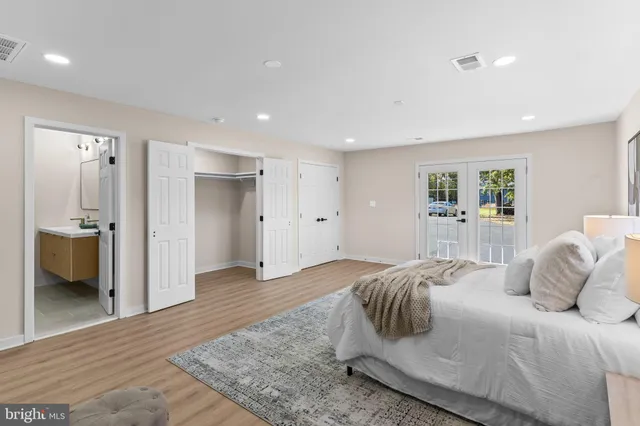 a bedroom with a large bed and a view of bathroom
