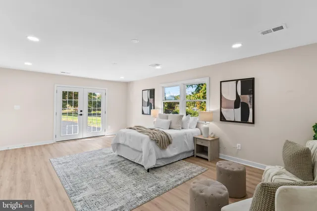 a living room with a bed furniture and a window