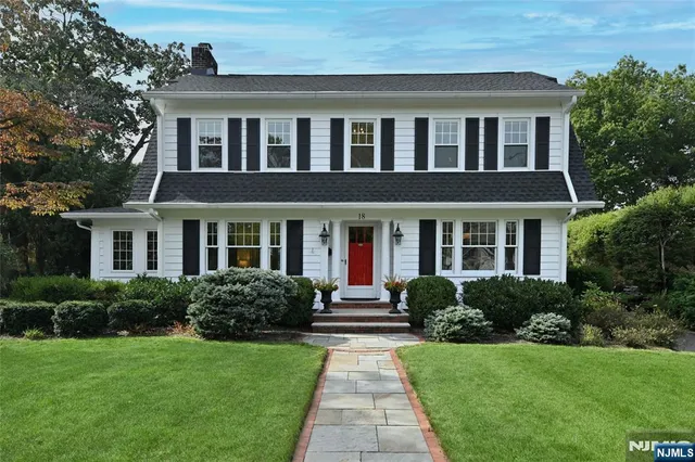 a front view of a house with garden and porch