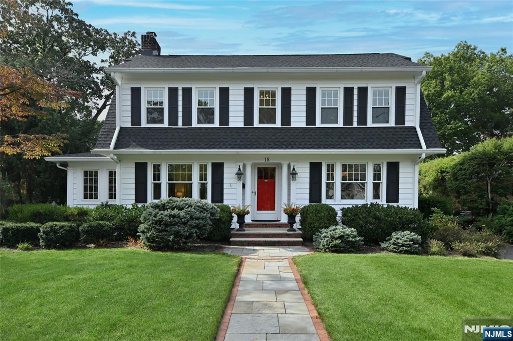 a front view of a house with garden and porch