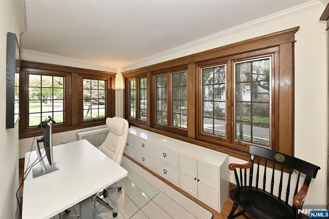 a living room with furniture and large windows