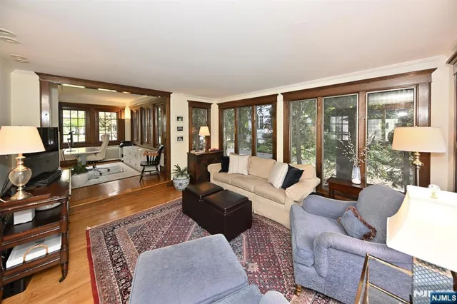 a living room with furniture large window and a table