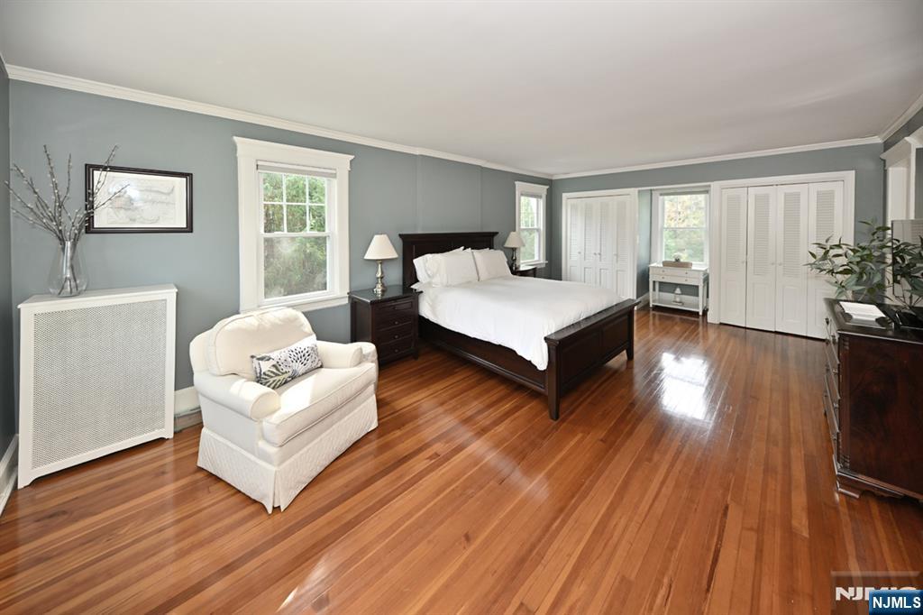 18 Tonawanda Road Glen Rock, NJ 07452 - Photo 17 of 37 a spacious bedroom with a bed and wooden floor