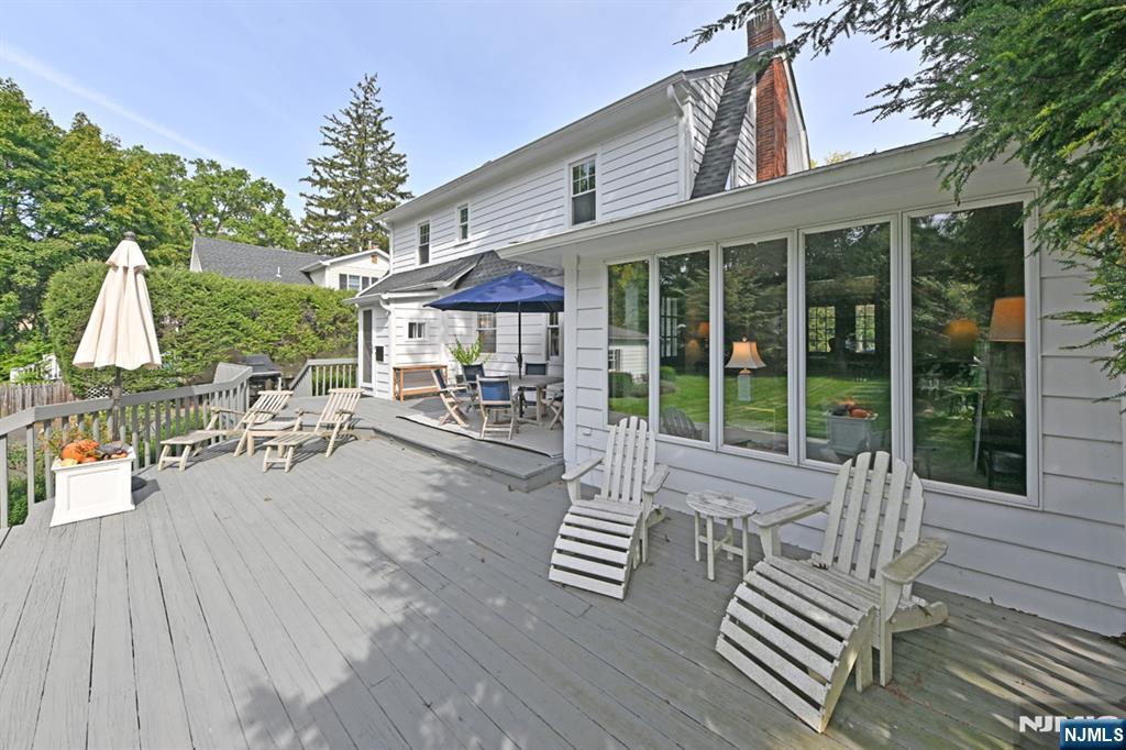 18 Tonawanda Road Glen Rock, NJ 07452 - Photo 27 of 37 a view of a patio with couches table and chairs and potted plants