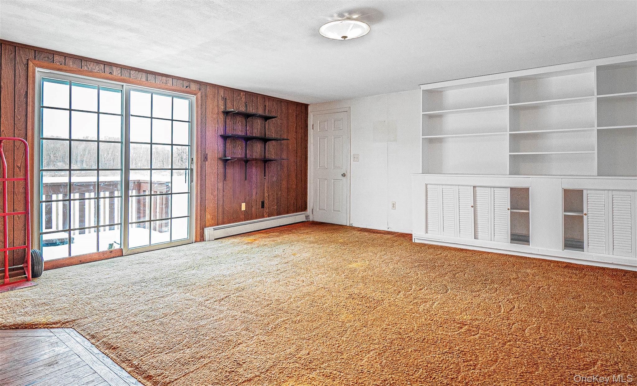 238 South Centerville Road Middletown, NY 10940 - Photo 10 of 30 Family room with built in features, wet bar, light carpet, a baseboard radiator, a textured ceiling, and wooden walls