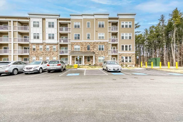 a buildings with cars parked in front of a building