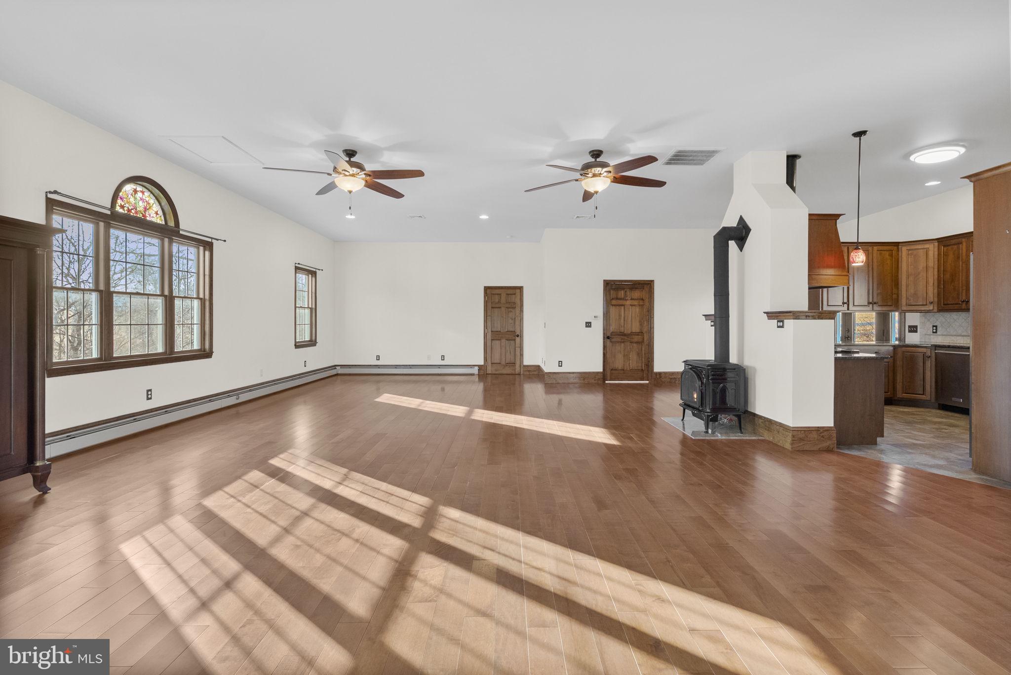 185 Spring Hollow Road Spring City, PA 19475 - Photo 11 of 33 a view of an empty room with kitchen appliances and a ceiling fan