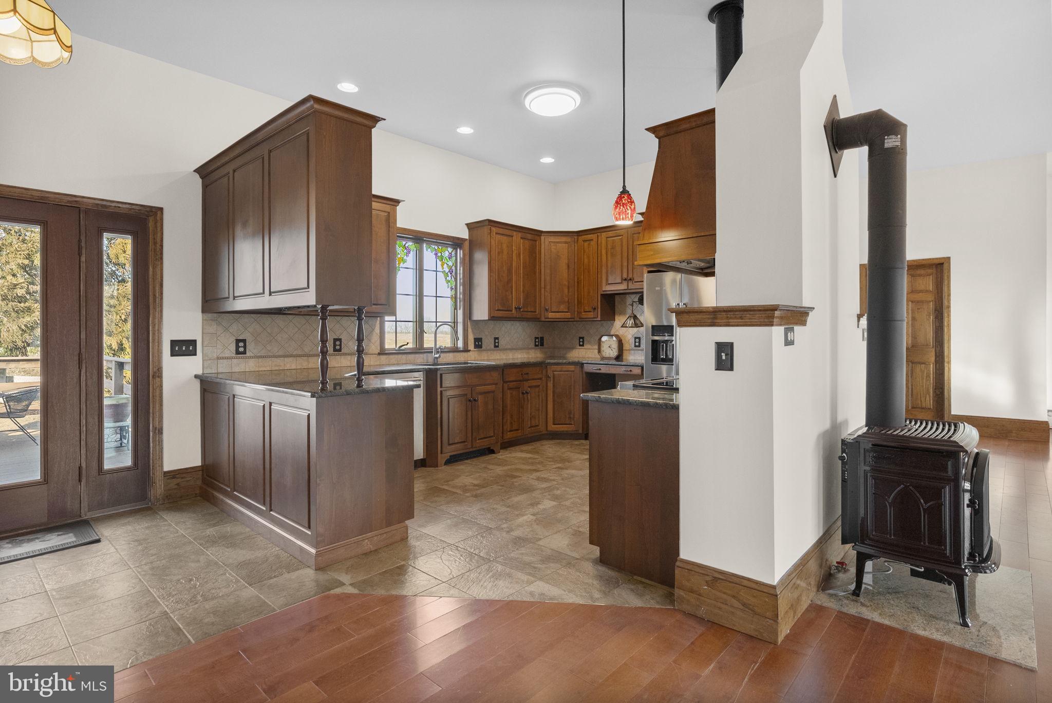 185 Spring Hollow Road Spring City, PA 19475 - Photo 12 of 33 a kitchen with a sink a counter top space stainless steel appliances and a window