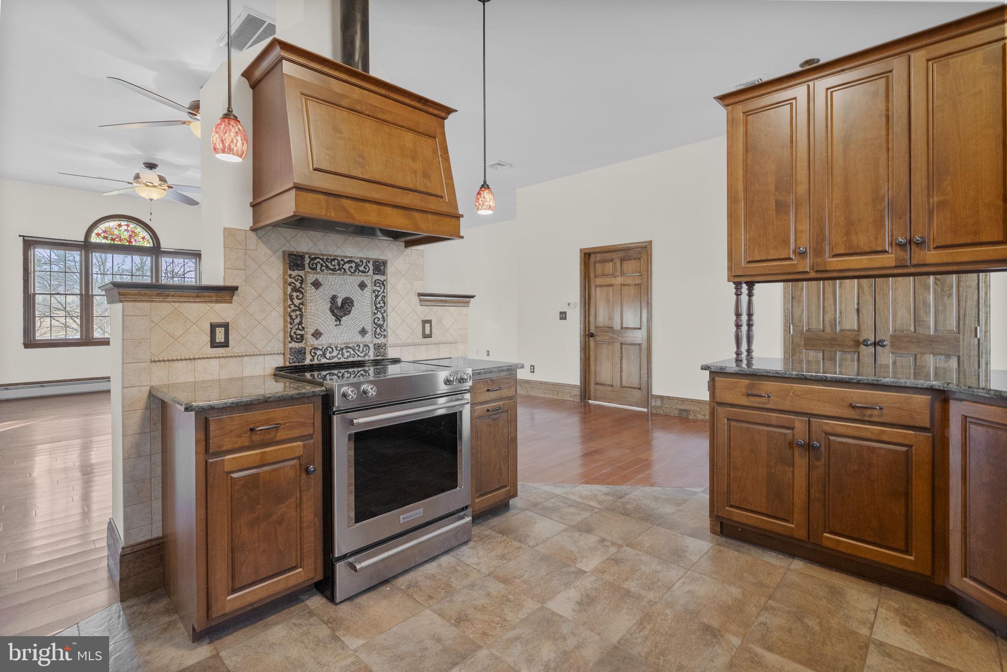 185 Spring Hollow Road Spring City, PA 19475 - Photo 14 of 33 a kitchen with stainless steel appliances granite countertop a stove and a microwave