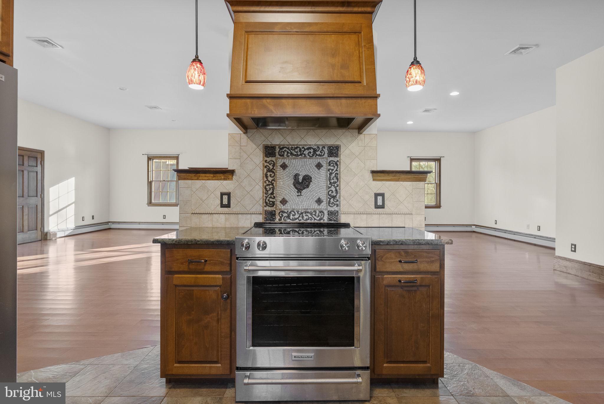 185 Spring Hollow Road Spring City, PA 19475 - Photo 15 of 33 a kitchen with stainless steel appliances granite countertop a stove and a microwave